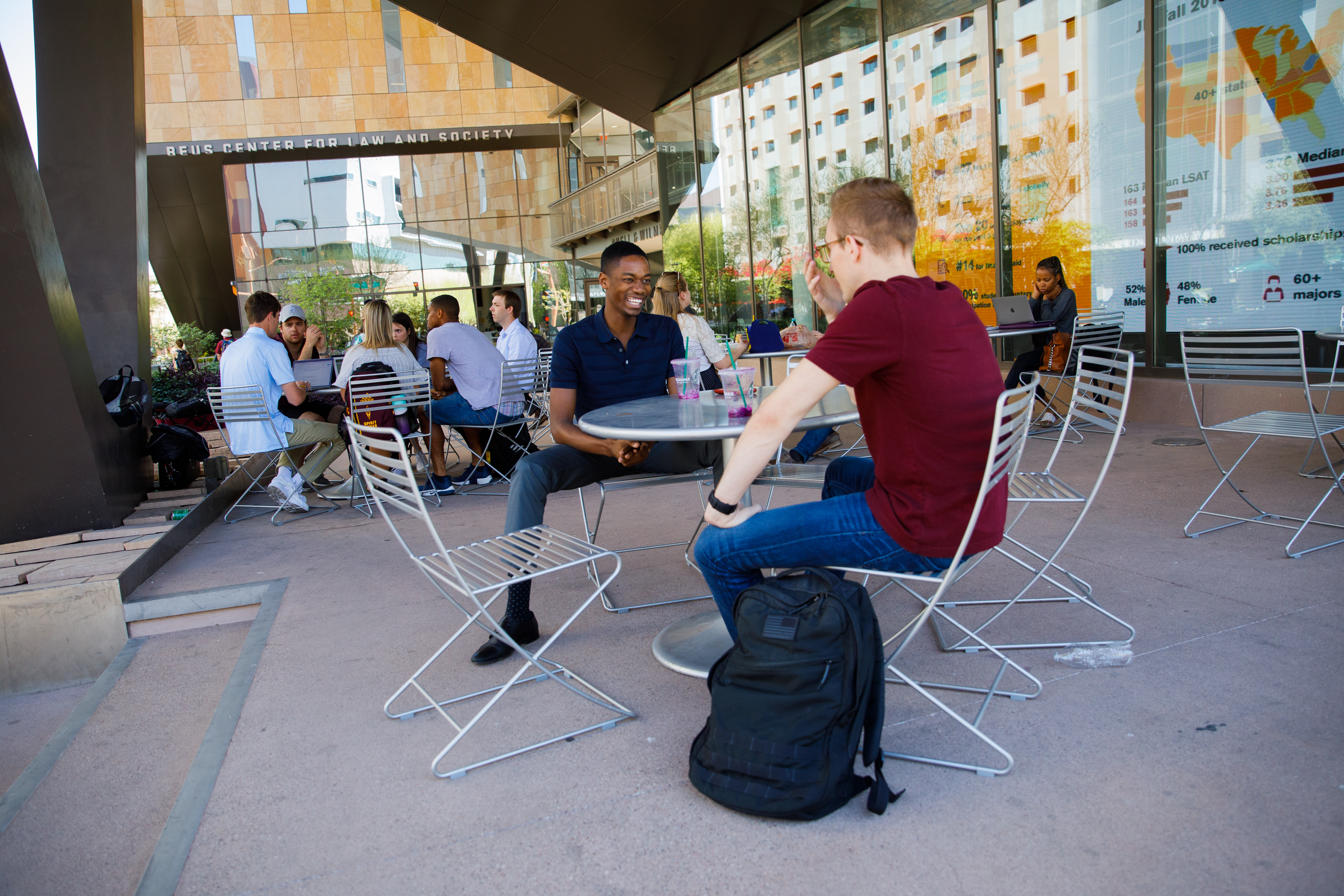 two students laughing and talking