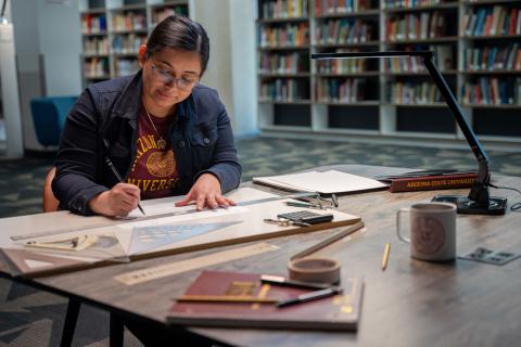Women in ASU shirt working 